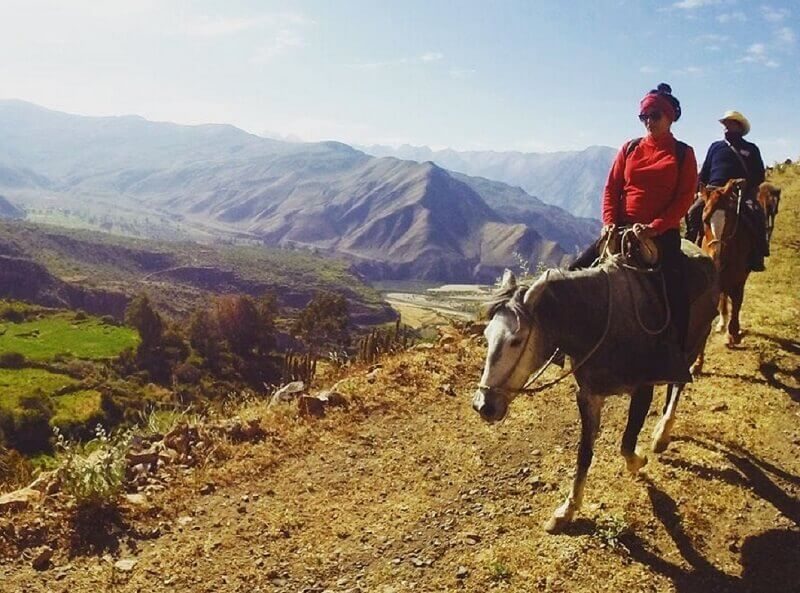 girl riding horse in the south of peru